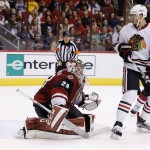 Chicago Blackhawks' Artem Anisimov (15) creates a screen on Arizona Coyotes goalie Anders Lindback (29), of Sweden, as Blackhawks' Artemi Panarin scores a goal as Coyotes' Nicklas Grossmann, right, of Sweden, watches during the first period of an NHL hockey game Tuesday, Dec. 29, 2015, in Glendale, Ariz. (AP Photo/Ross D. Franklin)
