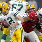 Green Bay Packers quarterback Aaron Rodgers (12) scrambles as Arizona Cardinals defensive end Calais Campbell (93) pursues during the first half of an NFL football game, Sunday, Dec. 27, 2015, in Glendale, Ariz. (AP Photo/Ross D. Franklin)