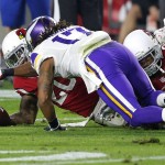 Arizona Cardinals strong safety Deone Bucannon (20), rear, forces Minnesota Vikings wide receiver Jarius Wright (17) to fumble as safety Rashad Johnson (26) defends during the first half of an NFL football game, Thursday, Dec. 10, 2015, in Glendale, Ariz. Bucannon recovered the fumble for the Cardinals. (AP Photo/Ross D. Franklin)