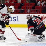 Arizona Coyotes' Tobias Rieder (8) puts the rebound from Carolina Hurricanes goalie Cam Ward (30) into the net for a goal during the first period of an NHL hockey game, Sunday, Dec. 6, 2015, in Raleigh, N.C. (AP Photo/Karl B DeBlaker)