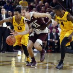 Texas A&M guard Alex Caruso (21) races for the loose ball with Arizona State guard Tra Holder (0) and Gerry Blakes during the second half of an NCAA college basketball game Saturday, Dec. 5, 2015, in Tempe, Ariz. Arizona State won 67-54. (AP Photo/Rick Scuteri)