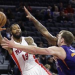 Detroit Pistons forward Marcus Morris (13) passes around the defense of Phoenix Suns forwards P.J. Tucker and Jon Leuer (30) during the first half of an NBA basketball game, Wednesday, Dec. 2, 2015, in Auburn Hills, Mich. (AP Photo/Carlos Osorio)