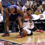 Washington Wizards guard Bradley Beal (3) battles for the ball against Phoenix Suns forward P.J. Tucker, left, during the first half of an NBA basketball game, Friday, Dec. 4, 2015, in Washington. (AP Photo/Nick Wass)