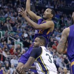 Phoenix Suns forward T.J. Warren (12) shoots as Utah Jazz forward Trevor Booker (33) defends during the first quarter of an NBA basketball game Monday, Dec. 21, 2015, in Salt Lake City. (AP Photo/Rick Bowmer)
