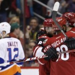 Arizona Coyotes' Oliver Ekman-Larsson (23), of Sweden, celebrates his goal against the New York Islanders with Anthony Duclair (10) and Tobias Rieder (8), of Germany, as Islanders' Josh Bailey (12) skates away during the first period of an NHL hockey game Saturday, Dec. 19, 2015, in Glendale, Ariz. (AP Photo/Ross D. Franklin)