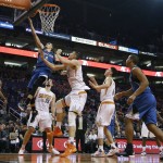 Minnesota Timberwolves' Zach LaVine (8) drives past Phoenix Suns' Alex Len (21), of Ukraine, to score as Suns' T.J. Warren (12), Mirza Teletovic (35), of Bosnia, Devin Booker (1), and Timberwolves' Shabazz Muhammad (15) and Andre Miller, right, watch during the second half of an NBA basketball game Sunday, Dec. 13, 2015 in Phoenix.  The Suns defeated the Timberwolves 108-101. (AP Photo/Ross D. Franklin)
