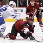 Arizona Coyotes' Brad Richardson (12) tries get the puck away from Toronto Maple Leafs' Tyler Bozak, left, during the first period of an NHL hockey game Tuesday, Dec. 22, 2015, in Glendale, Ariz. (AP Photo/Ross D. Franklin)