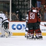 Arizona Coyotes' Tobias Rieder, left, Antoine Vermette (50) and Oliver Ekman-Larsson, right, celebrate Ekman-Larsson's goal as Los Angeles Kings goalie Jonathan Quick (32) pushes the puck out of the net during the first period of an NHL hockey game Saturday, Dec. 26, 2015, in Glendale, Ariz. (AP Photo/Ralph Freso)