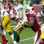 Green Bay Packers quarterback Aaron Rodgers (12) is sacked by Arizona Cardinals outside linebacker Alex Okafor (57) during the second half of an NFL football game, Sunday, Dec. 27, 2015, in Glendale, Ariz. (AP Photo/Ross D. Franklin)