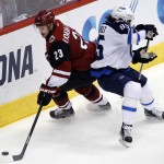 Arizona Coyotes defenseman Oliver Ekman-Larsson (23) shields Winnipeg Jets center Mathieu Perreault from the puck in the first period during an NHL hockey game, Thiursday, Dec. 31, 2015, in Glendale, Ariz. (AP Photo/Rick Scuteri)