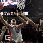 Arizona forward Ryan Anderson (12) works his way under the basket against the Long Beach State defense during the second half of an NCAA college basketball game Tuesday, Dec. 22, 2015, in Tucson, Ariz. (Kelly Presnell/Arizona Daily Star via AP)