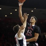 Fresno State forward Cullen Russo (13) shoots over Arizona forward Mark Tollefsen during the first half of an NCAA college basketball game, Wednesday, Dec. 9, 2015, in Tucson, Ariz. (AP Photo/Rick Scuteri)