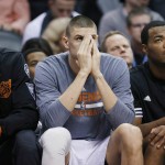 Phoenix Suns' Tyson Chandler, Alex Len, and T.J. Warren, from left, on the bench during the second half of the team's NBA basketball game against the Denver Nuggets on Wednesday, Dec. 23, 2015, in Phoenix. The Nuggets defeated the Suns 104-96. (AP Photo/Ross D. Franklin)