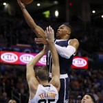 Oklahoma City Thunder guard Russell Westbrook shoots in front of Phoenix Suns' Mirza Teletovic (35) and guard Devin Booker, right, in the first quarter of an NBA basketball game in Oklahoma City, Thursday, Dec. 31, 2012. (AP Photo/Sue Ogrocki)