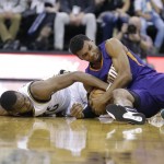Utah Jazz guard Alec Burks, left, and Phoenix Suns guard Ronnie Price, right, vie for a loose ball during the second half of an NBA basketball game Monday, Dec. 21, 2015, in Salt Lake City. The Jazz won 110-89. (AP Photo/Rick Bowmer)