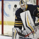 Buffalo Sabres goaltender Chad Johnson knocks away the puck during the second period of an NHL hockey game against the Arizona Coyotes on Friday, Dec. 4, 2015, in Buffalo, N.Y. (AP Photo/Gary Wiepert)