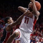 Arizona guard Allonzo Trier, right, gets fouled by UNLV guard Jerome Seagears, left, during the second half of an NCAA college basketball game, Saturday, Dec. 19, 2015, in Tucson, Ariz. Arizona defeated UNLV 82-70. (AP Photo/Rick Scuteri)