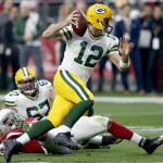 Green Bay Packers quarterback Aaron Rodgers (12) scrambles against the Arizona Cardinals during the first half of an NFL football game, Sunday, Dec. 27, 2015, in Glendale, Ariz. (AP Photo/Rick Scuteri)