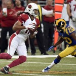 Arizona Cardinals wide receiver Larry Fitzgerald, left, catches a pass as St. Louis Rams cornerback Lamarcus Joyner defends during the first quarter of an NFL football game on Sunday, Dec. 6, 2015, in St. Louis. (AP Photo/L.G. Patterson)