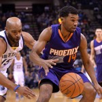 Memphis Grizzlies guard Vince Carter (15) tries to steal the ball from Phoenix Suns guard Ronnie Price (14) in the first half of an NBA basketball game Sunday, Dec. 6, 2015, in Memphis, Tenn. (AP Photo/Brandon Dill)