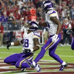 Minnesota Vikings running back Adrian Peterson (28) celebrates his touchdown run against the Arizona Cardinals with teammate Stefon Diggs (14) during the first half of an NFL football game, Thursday, Dec. 10, 2015, in Glendale, Ariz. (AP Photo/Ross D. Franklin)
