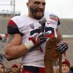 Arizona linebacker Scooby Wright III thanks the support of the crowd while receiving the Defensive Player of the Game award after the New Mexico Bowl NCAA college football game against New Mexico in Albuquerque, N.M., Saturday, Dec. 19, 2015. Arizona won 45-37. (AP Photo/Andres Leighton)