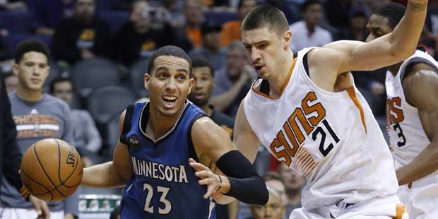 Minnesota Timberwolves' Kevin Martin (23) drives past Phoenix Suns' Alex Len (21), of Ukraine, duri...
