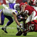 Arizona Cardinals strong safety Deone Bucannon (20) forces Minnesota Vikings wide receiver Jarius Wright (17) to fumble as free safety Rashad Johnson (26) during the first half of an NFL football game, Thursday, Dec. 10, 2015, in Glendale, Ariz. Bucannon recovered the fumble for the Cardinals. (AP Photo/Rick Scuteri)