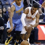 Denver Nuggets' Gary Harris. left, and Phoenix Suns' Ronnie Price vie for a loose ball during the second half of an NBA basketball game Wednesday, Dec. 23, 2015, in Phoenix. The Nuggets defeated the Suns 104-96. (AP Photo/Ross D. Franklin)