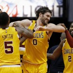 Cleveland Cavaliers' Kevin Love (0) smiles as he is helped up off the floor by teammates Kyrie Irving (2), J.R. Smith (5) and Tristan Thompson, left, during the first half of an NBA basketball game against the Phoenix Suns Monday, Dec. 28, 2015, in Phoenix. (AP Photo/Ross D. Franklin)