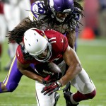 Arizona Cardinals wide receiver Larry Fitzgerald (11) is hit by Minnesota Vikings cornerback Trae Waynes (26) during the first half of an NFL football game, Thursday, Dec. 10, 2015, in Glendale, Ariz. (AP Photo/Ross D. Franklin)