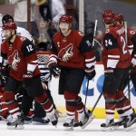 Arizona Coyotes' Shane Doan (19) smiles after celebrating his goal against the Chicago Blackhawks with teammates Brad Richardson (12), Kyle Chipchura (24) and Nicklas Grossmann (2), of Sweden, during the first period of an NHL hockey game Tuesday, Dec. 29, 2015, in Glendale, Ariz. (AP Photo/Ross D. Franklin)