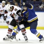 St. Louis Blues' Troy Brouwer, right, gets tangled up with Arizona Coyotes' Anthony Duclair while chasing after the puck during the first period of an NHL hockey game Tuesday, Dec. 8, 2015, in St. Louis. (AP Photo/Jeff Roberson)