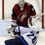 Arizona Coyotes goalie Louis Domingue (35) makes a save against Winnipeg Jets right wing Blake Wheeler in the second period during an NHL hockey game, Thursday, Dec. 31, 2015, in Glendale, Ariz. (AP Photo/Rick Scuteri)