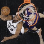 San Antonio Spurs center Boris Diaw (33) scores past Phoenix Suns forward Mirza Teletovic (35) during the first half of an NBA basketball game Wednesday, Dec. 30, 2015, in San Antonio. (AP Photo/Eric Gay)