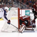 Arizona Coyotes' Anders Lindback (29), of Sweden, makes a save on a shot by Columbus Blue Jackets' David Clarkson (23) as Coyotes' Nicklas Grossmann (2), of Sweden, defends during the first period of an NHL hockey game, Thursday, Dec. 17, 2015, in Glendale, Ariz. (AP Photo/Ross D. Franklin)