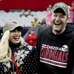 Singers Gwen Stephani and Blake Shelton stand on the sidelines prior to an NFL football game between the Green Bay Packers and the Arizona Cardinals, Sunday, Dec. 27, 2015, in Glendale, Ariz. (AP Photo/Ross D. Franklin)