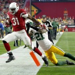 Arizona Cardinals running back David Johnson (31) scores a touchdown as Green Bay Packers free safety Ha Ha Clinton-Dix (21) defends during the second half of an NFL football game, Sunday, Dec. 27, 2015, in Glendale, Ariz. (AP Photo/Ross D. Franklin)