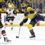 Nashville Predators center Craig Smith (15) shoots as he is defended by Arizona Coyotes' Oliver Ekman-Larsson (23), of Sweden, in the second period of an NHL hockey game, Tuesday, Dec. 1, 2015, in Nashville, Tenn. (AP Photo/Mark Humphrey)