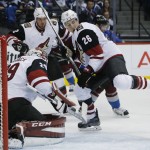 Arizona Coyotes goalie Anders Lindback (29), front, left, of Sweden, stops shot as defenseman Michael Stone, front right, pursues the puck while checking Colorado Avalanche center Matt Duchene, back, right, in the first period of an NHL hockey game Sunday, Dec. 27, 2015, in Denver. (AP Photo/David Zalubowski)