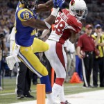 St. Louis Rams wide receiver Kenny Britt (18) lands out of bounds for an incomplete pass as Arizona Cardinals cornerback Justin Bethel defends before the start of an NFL football game between the St. Louis Rams and the Arizona Cardinals on Sunday, Dec. 6, 2015, in St. Louis. (AP Photo/Jeff Roberson)