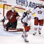Columbus Blue Jackets' Alexander Wennberg (41), of Sweden, celebrates his goal with Scott Hartnell (43) as Arizona Coyotes' Anders Lindback, left, of Sweden, looks on during the second period of an NHL hockey game, Thursday, Dec. 17, 2015, in Glendale, Ariz. (AP Photo/Ross D. Franklin)