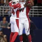 Arizona Cardinals running back David Johnson, right, is congratulated by teammate J.J. Nelson after catching a 10-yard pass for a touchdown during the third quarter of an NFL football game against the St. Louis Rams  on Sunday, Dec. 6, 2015, in St. Louis. (AP Photo/Tom Gannam)
