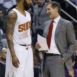 Phoenix Suns head coach Jeff Hornacek, right, talks with Markieff Morris, left, during the first half of an NBA basketball game against the Denver Nuggets Wednesday, Dec. 23, 2015, in Phoenix. (AP Photo/Ross D. Franklin)
