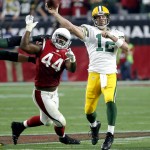 Green Bay Packers quarterback Aaron Rodgers (12) throws under pressure from Arizona Cardinals outside linebacker Markus Golden (44) during the second half of an NFL football game, Sunday, Dec. 27, 2015, in Glendale, Ariz. (AP Photo/Ross D. Franklin)