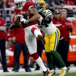 Arizona Cardinals wide receiver Michael Floyd (15) makes a catch as Green Bay Packers cornerback Quinten Rollins (24) defends during the first half of an NFL football game, Sunday, Dec. 27, 2015, in Glendale, Ariz. (AP Photo/Ross D. Franklin)