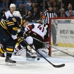 Buffalo Sabres left winger Jamie McGinn (88) reaches for the puck as Arizona Coyotes goaltender Mike Smith (41) scrambles to get back into the play during the first period of an NHL hockey game, Friday Dec. 4, 2015, in Buffalo, N.Y. (AP Photo/Gary Wiepert)