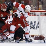 Carolina Hurricanes' Jeff Skinner (53) and Arizona Coyotes' Michael Stone (26) battle for the puck during the second period of an NHL hockey game Saturday, Dec. 12, 2015 in Glendale, Ariz. (AP Photo/Ross D. Franklin)