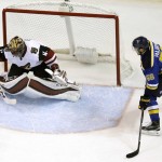 Arizona Coyotes goalie Mike Smith, left, deflects a puck as St. Louis Blues' Magnus Paajarvi watches during the first period of an NHL hockey game Tuesday, Dec. 8, 2015, in St. Louis. (AP Photo/Jeff Roberson)