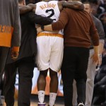 
              Phoenix Suns guard Eric Bledsoe (2) is helped off the court in the second quarter during an NBA basketball game against the Philadelphia 76ers, Saturday, Dec. 26, 2015, in Phoenix. (AP Photo/Rick Scuteri)
            